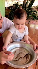 Baby Tries to Put Fish in Mouth During Sensory Activity