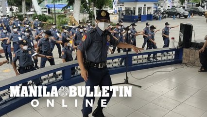Policemen warm up at the Manila Police District before deployment for the National and Local Elections