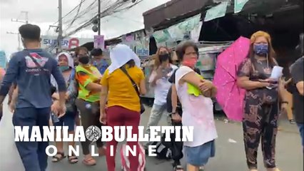 Voters form long lines outside of Jose Rizal Elementary School in Tondo, Manila
