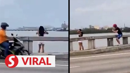 Tourist poses over Penang Bridge parapet, stuns motorists