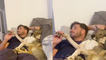 'Pampered doggy gets his paws massaged while watching TV with owner '
