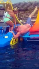 Man's Swim Trunks Caught on Floating Slide