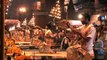 Hindu priests hold lit multi-tiered aarti lamps during Ganga Aarti, Varanasi