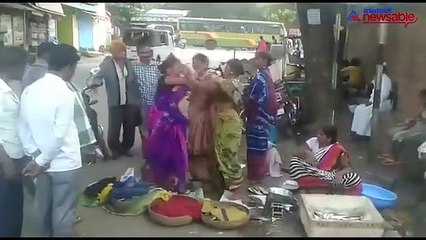 Two fisher-women get into an abusive fight over customers