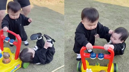 'Cute baby having a hard time using a walking aid *Never Give Up!*'