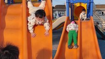 'Baby boys show fun, different ways of sliding down a twin slide '