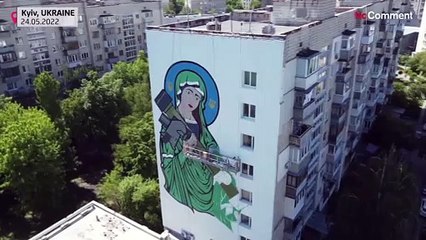 Giant mural of armed saint painted on Kyiv building
