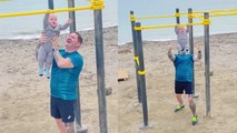 'SMOL but STRONG baby boy hangs from a pull-up bar without any support '