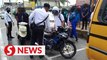 25 students riding motorcycles slapped with summonses while exiting school