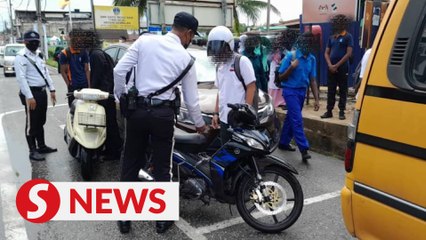 25 students riding motorcycles slapped with summonses while exiting school