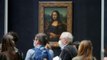 Man dressed as old woman smears cake on Mona Lisa portrait at Louvre in Paris