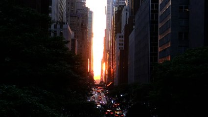 Manhattanhenge lights up buildings with a city sunset on Memorial Day