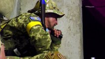 Ukrainian soldiers watch their country's win over Scotland in World Cup qualifier