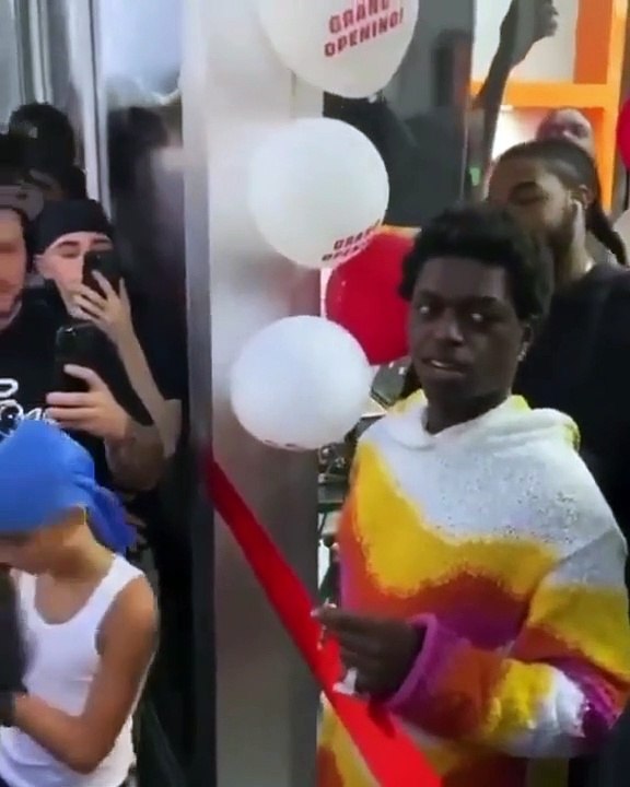 Kodak Black cuts the ribbon at the opening of his Miami boutique