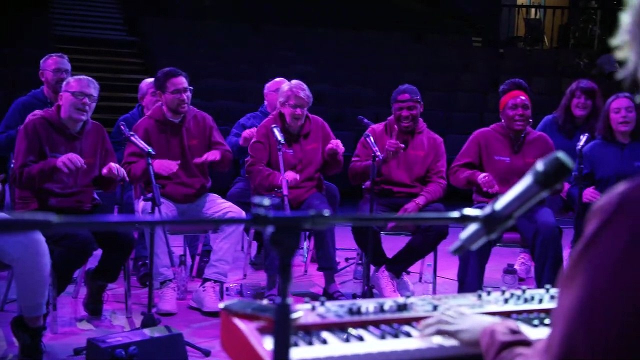 Alex Oxlade-Chamberlain plays drums with the combined choirs of Liverpool Lighthouse