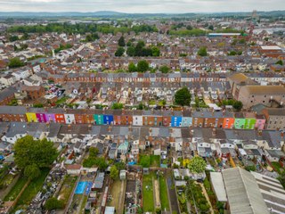 Artist transforming city by painting its houses different colours unveils her latest street of 63 'rainbow' homes