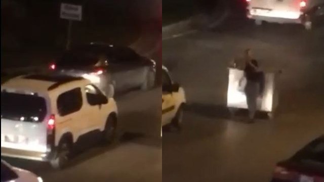 Çöp konteynerini yol ortasına çekip içki masası yaptı, sürücülere zor anlar yaşattı