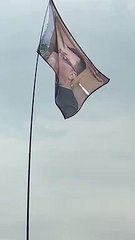 Burnley man Kevin Riley appears on the face of a flag at Glastonbury Festival