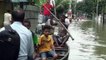 Residents navigate through flooded streets in northeast Bangladesh