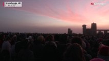 Sun rises behind Stonehenge on summer solstice