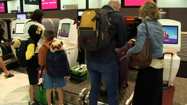 Travellers face delays at airports as school holidays begin