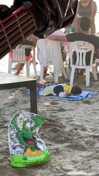 Napping Child is Woken Up By Waves