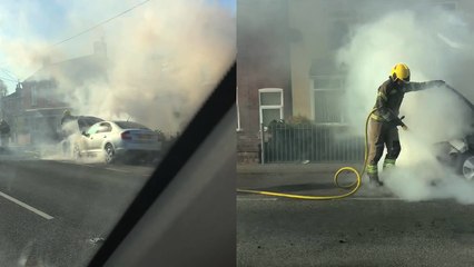 'Captivating scene of a man driving past a car ON FIRE!!!'
