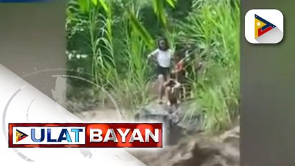 Anim na bata, na-trap sa gitna ng  rumaragasang ilog