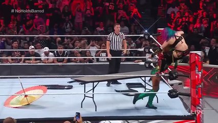 Becky Lynch splinters Asuka through a table