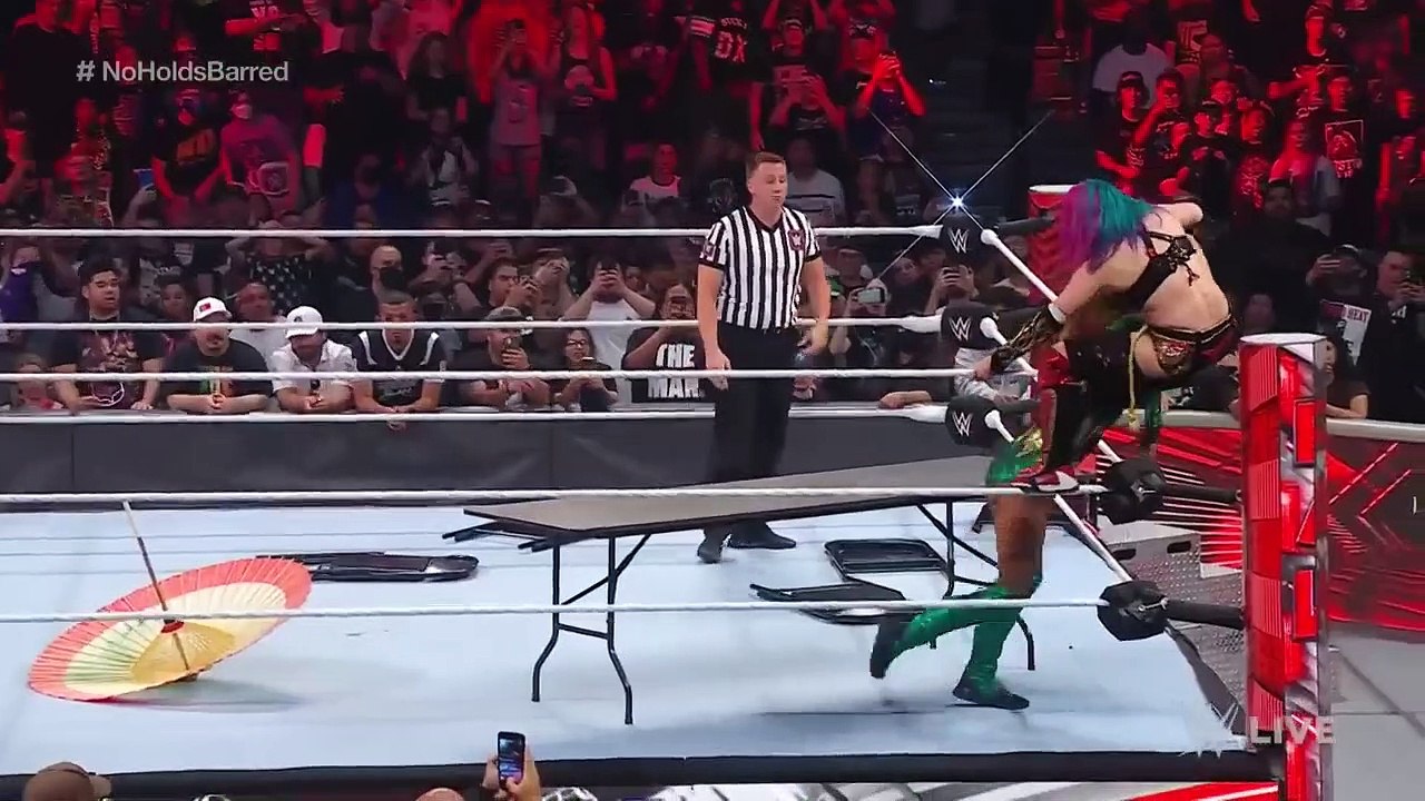 Becky Lynch splinters Asuka through a table