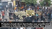 Protesters break down barricades near presidential residence in Colombo as Sri Lanka leader flees