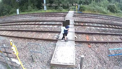 Terrifying CCTV shows young children playing and dancing on rail tracks in front of a moving train