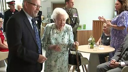 Queen makes light of ringing mobile during hospice visit