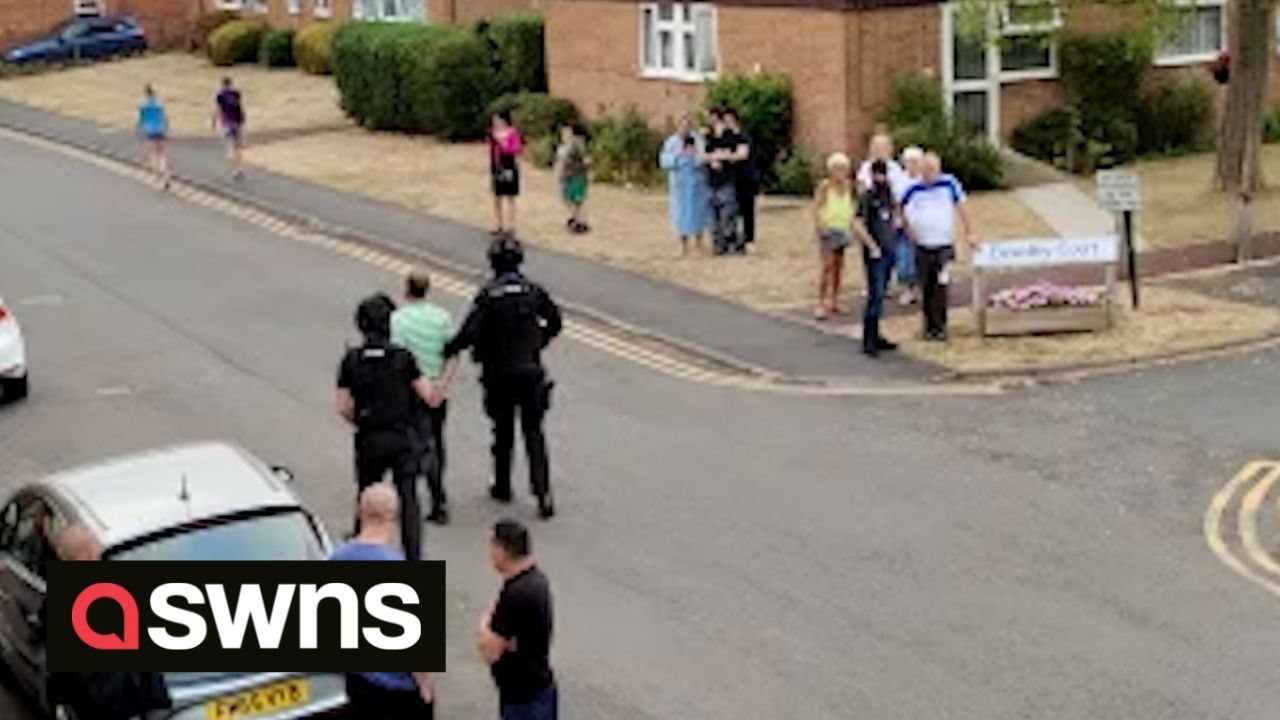 Dramatic footage shows armed cops arrest suspected gunman in front of shocked residents