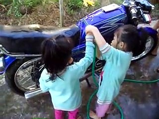 beautiful twins washing motorbikes.
