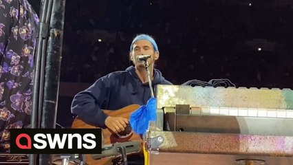 Ukrainian man performs at sold-out Coldplay gig after being approached by frontman Chris Martin while busking in Warsaw