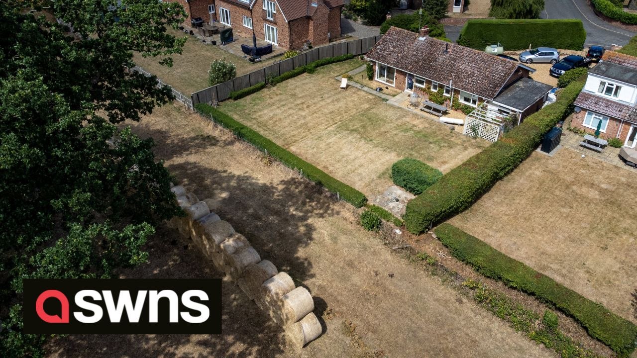 Millionaire estate owner builds wall of hay bal...