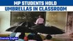 MP: Tribal students hold umbrellas in classroom as roof leaks in school | Oneindia News *viralvideo
