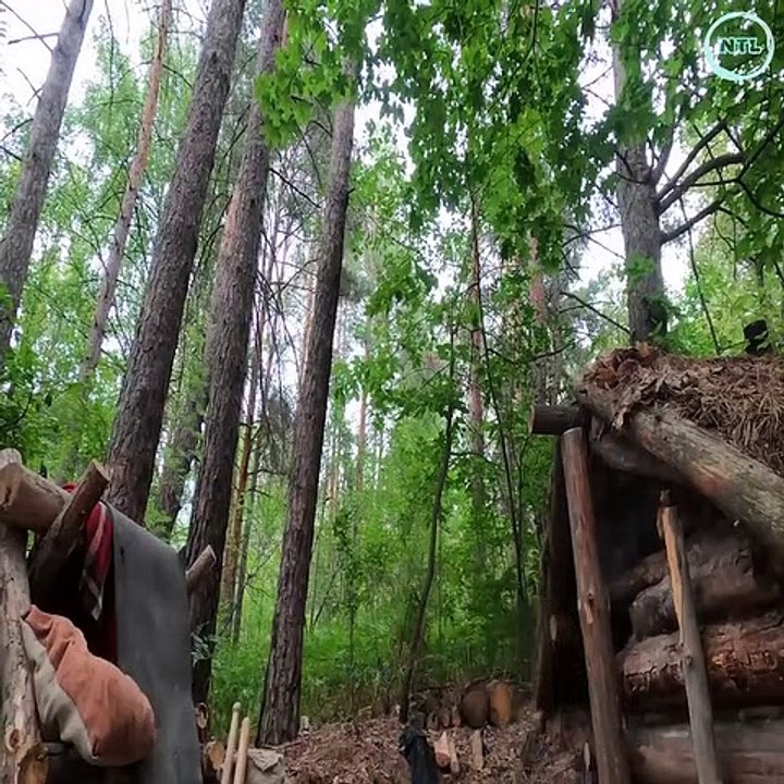Discovering an abandoned survival shelter, he cleaned and repaired the bed to spend the night in the rain and storm.