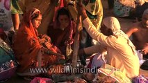 Priest performing Hindu rituals with new born baby and his family during Maha shivratri at varanasi