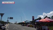 Tourists look on from Pingtan Island at China's live-firing military drill amid tensions over Taiwan