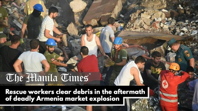 Rescue workers clear debris in the aftermath of deadly Armenia market explosion