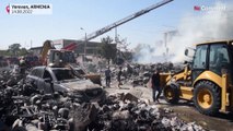 Firefighters douse the flames after an explosion at a market in Yerevan