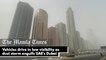 Vehicles drive in low visibility as dust storm engulfs UAE's Dubai