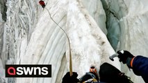 Climber navigates narrow snow bridge above 3000m crevasse in the French Alps