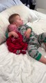 big brother adorably cuddles with newborn baby