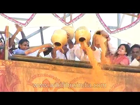 Jain devotees pour turmeric paste on 18 meter high statue of Lord Bahubali