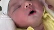 newborn baby preciously smiles when kissed