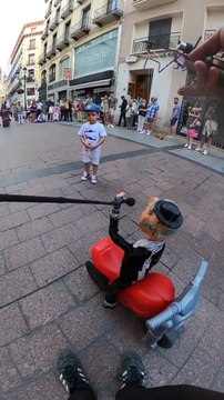 Puppeteer Improvises With a Child at Street Show