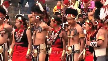 Phom Naga tribes-men dressed scantily and dancing merrily, Nagaland